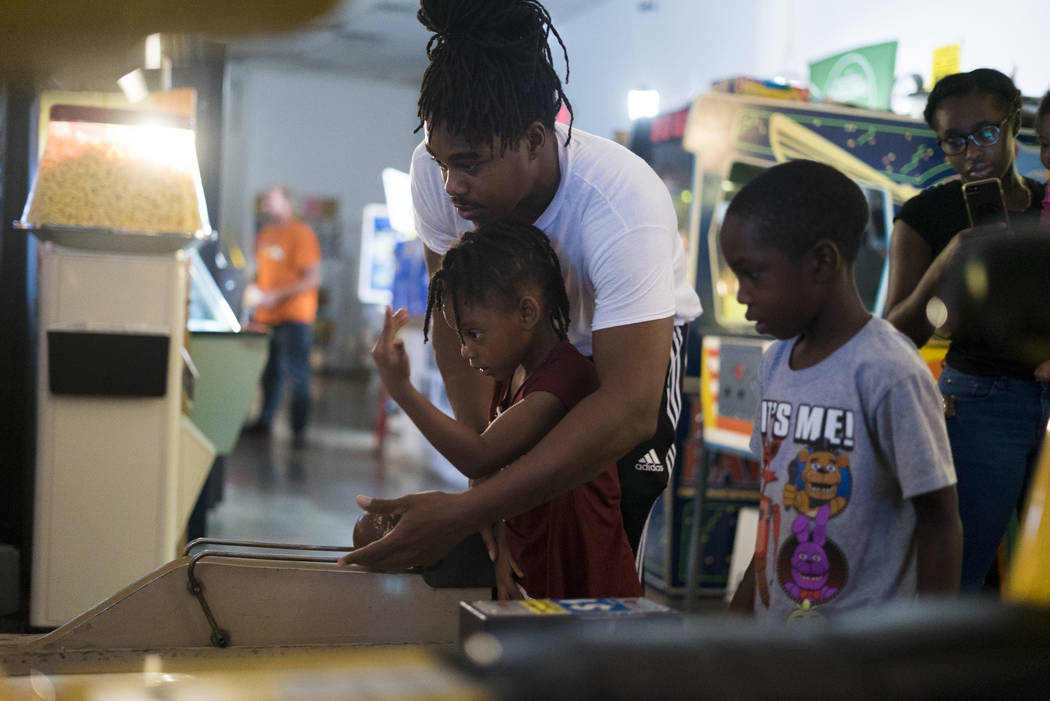 Azo McMiller bowls with daughter Azalea, 5, and son Azo Jr., 7, at the Pinball Hall of Fame in ...