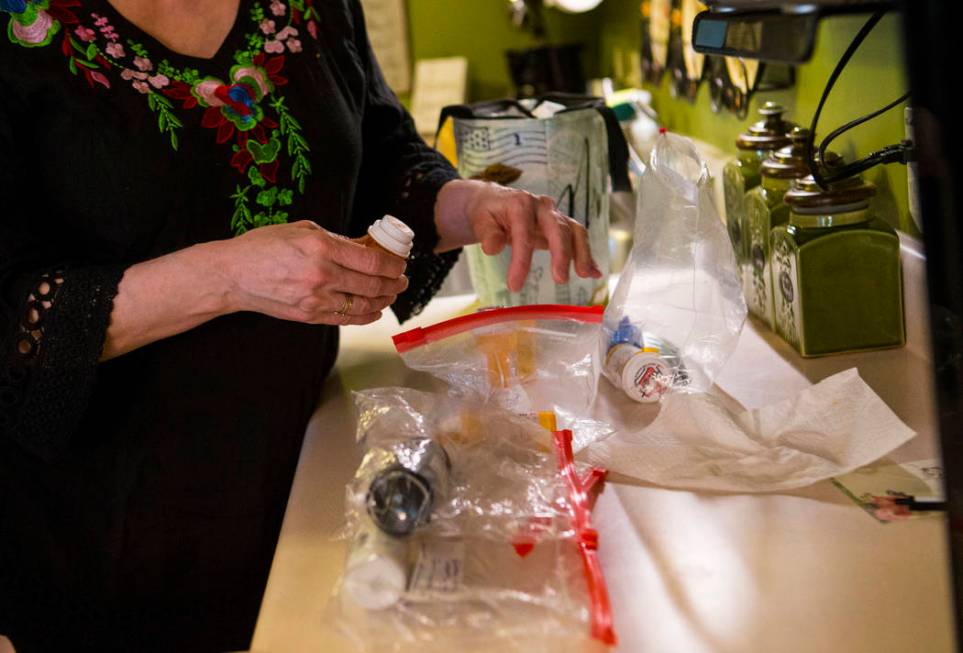 Kay McClure prepares medication for her son, Grayson McClure, at their home in Collierville, Te ...