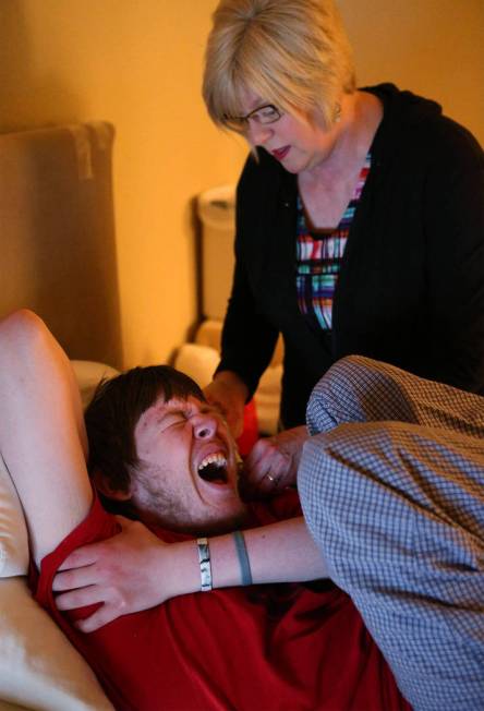 Kay McClure administers medicine to her son Grayson in their Reno home on Monday, May 9, 2016. ...