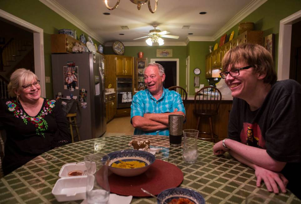 Grayson McClure, right, shares a laugh with his parents, Kay McClure, left, and Terry McClure, ...