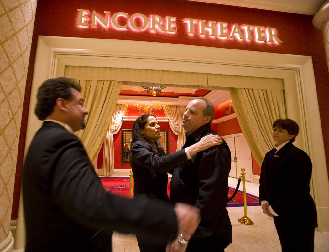 Encore Theater ushers, Max Marquez, left to right, Ned Rohani and Karen Swigart hug Chip Light ...