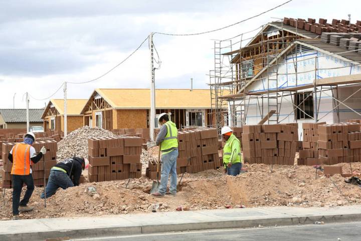 Construction workers build wall during the new construction of LGI Homes at the Intersection of ...