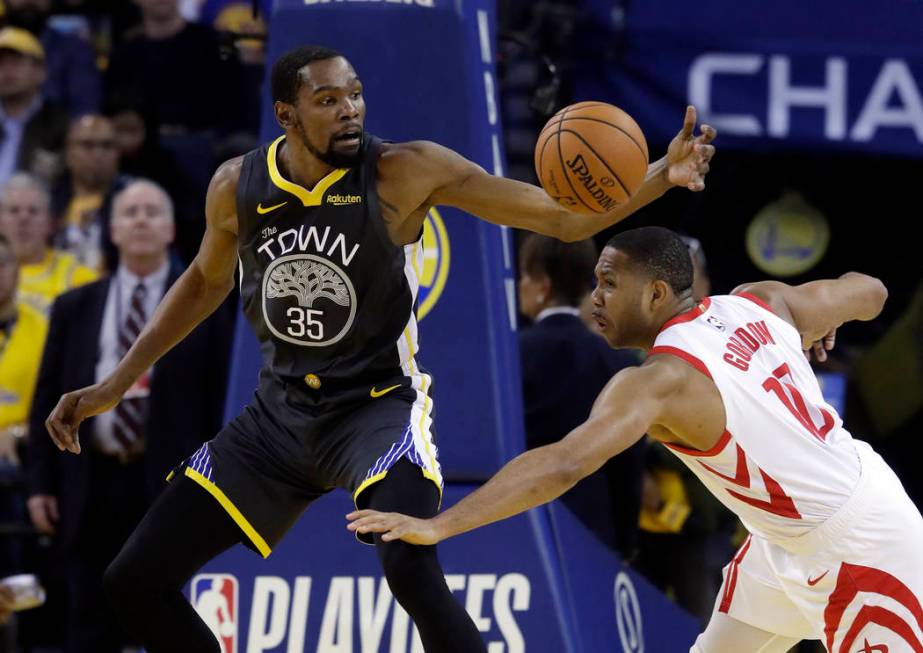 Golden State Warriors' Kevin Durant (35) is defended by Houston Rockets' Eric Gordon during the ...