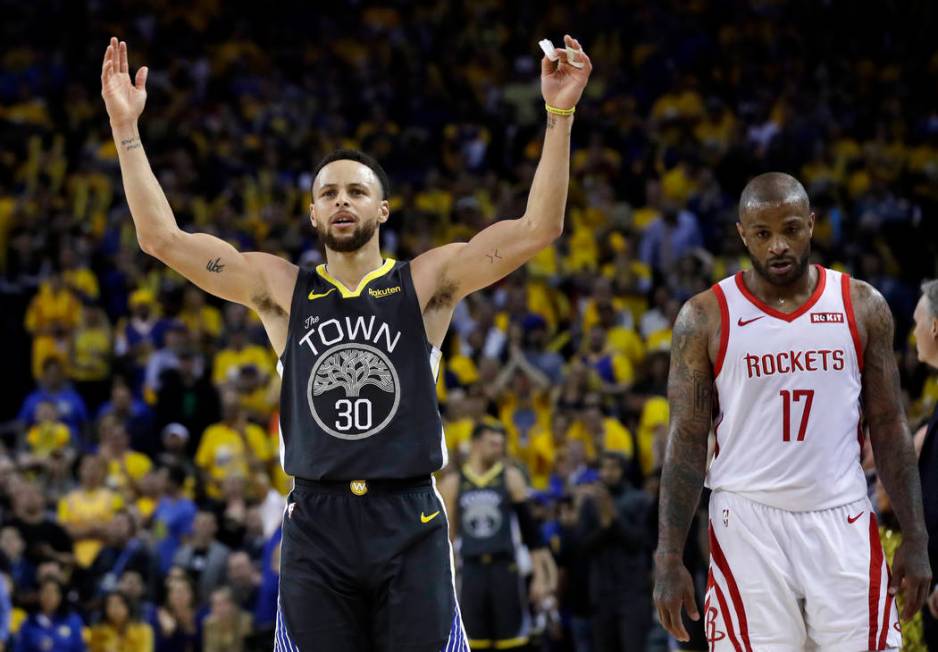 Golden State Warriors' Stephen Curry, left, celebrates next to Houston Rockets' PJ Tucker durin ...