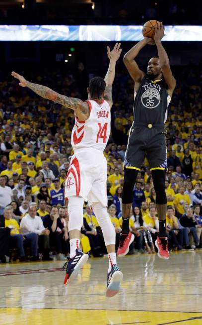 Golden State Warriors' Kevin Durant, right, shoots over Houston Rockets' Gerald Green during th ...