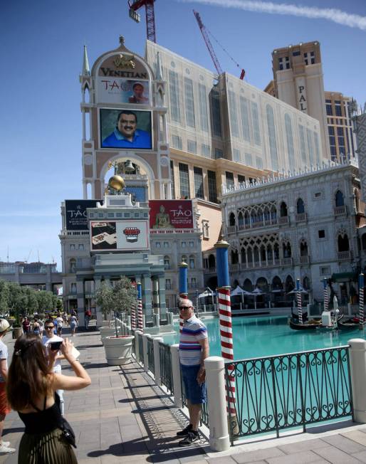 Portraits of founding employees are displayed on The Venetian marquee to celebrate the 20th ann ...