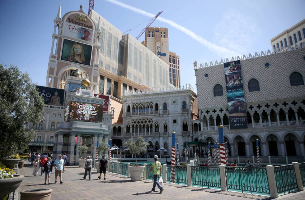 Portraits of founding employees are displayed on The Venetian marquee to celebrate the 20th ann ...