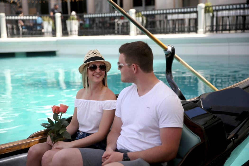 Shannon Terhaar and Layne Chapman of Minneapolis get free roses while taking a gondola ride at ...