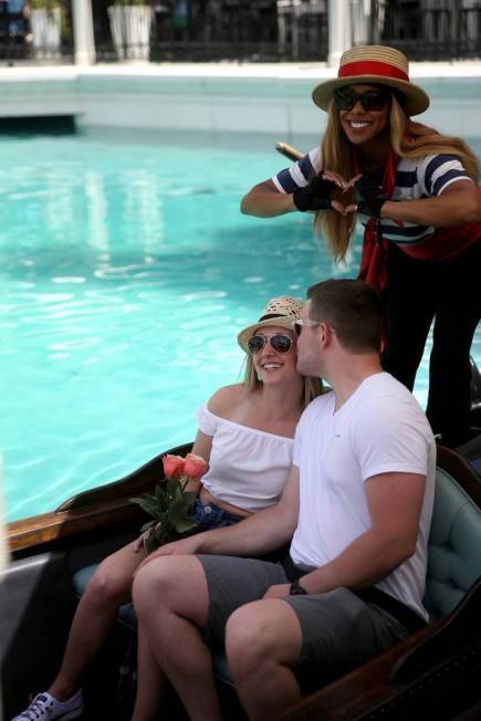 Shannon Terhaar and Layne Chapman of Minneapolis pose with gondolier Coco and free roses at The ...