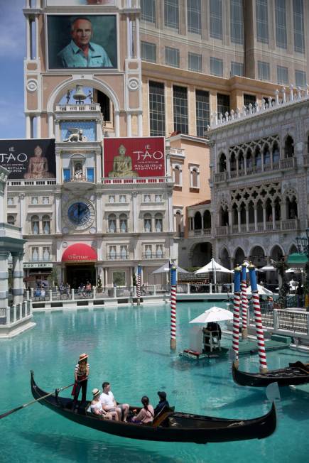 Portraits of founding employees are displayed on The Venetian marquee to celebrate the 20th ann ...