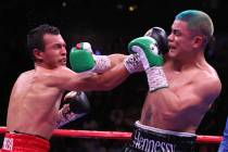 Joseph Diaz Jr., right, connects a punch against Freddy Fonseca in the super featherweight titl ...