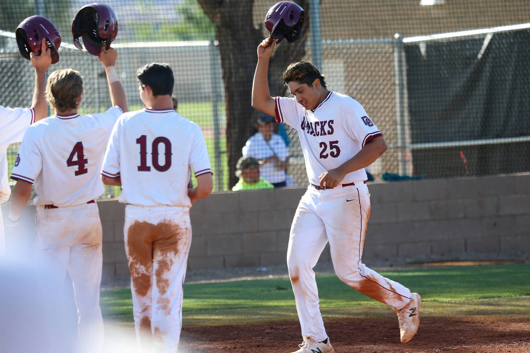 Desert Oasis' Aaron Roberts (25) runs home after hitting a three run homer against Basic in the ...