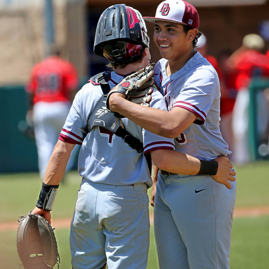 Desert Oasis' pitcher Aaron Roberts (25), right, embraces catcher Parker Schmidt (4) after str ...