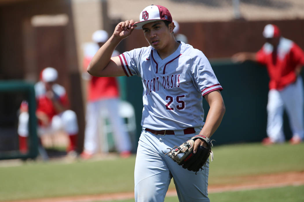 Desert Oasis' pitcher Aaron Roberts (25) walks to the dugout after striking out a player to end ...