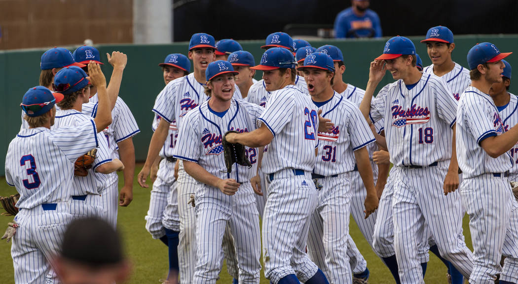 Reno players celebrate another run and a dominating score versus Las Vegas during their state b ...