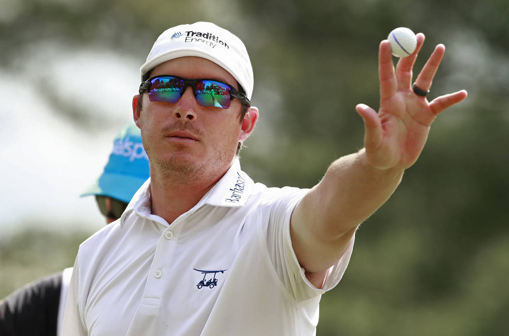 Joel Dahmen holds up the ball after a bogey putt on the ninth hole during the final round of th ...