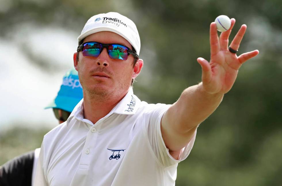 Joel Dahmen holds up the ball after a bogey putt on the ninth hole during the final round of th ...