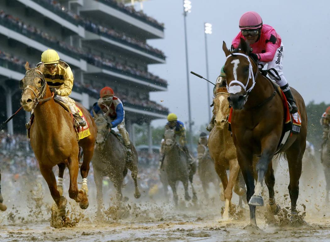 Luis Saez rides Maximum Security, right, across the finish line first against Flavien Prat on C ...