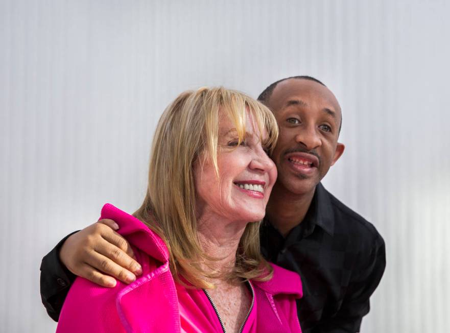 Author Linda Smith, left, takes a photo with Reggie Daniel during a reading and book signing f ...