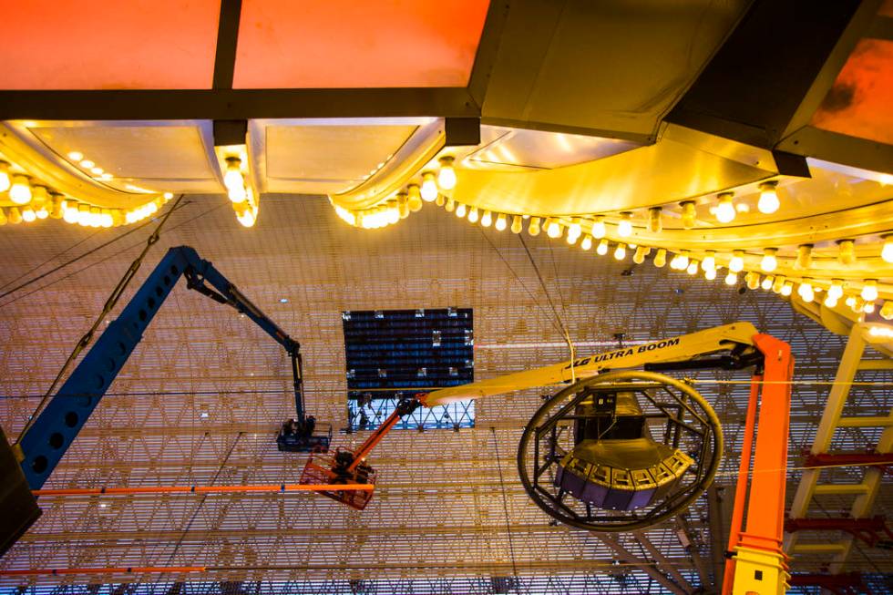 Construction workers use a lift during the second day of renovations of the Viva Vision canopy ...