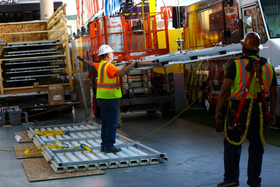 Construction workers prepare to installl a new panel during the second day of renovations of th ...