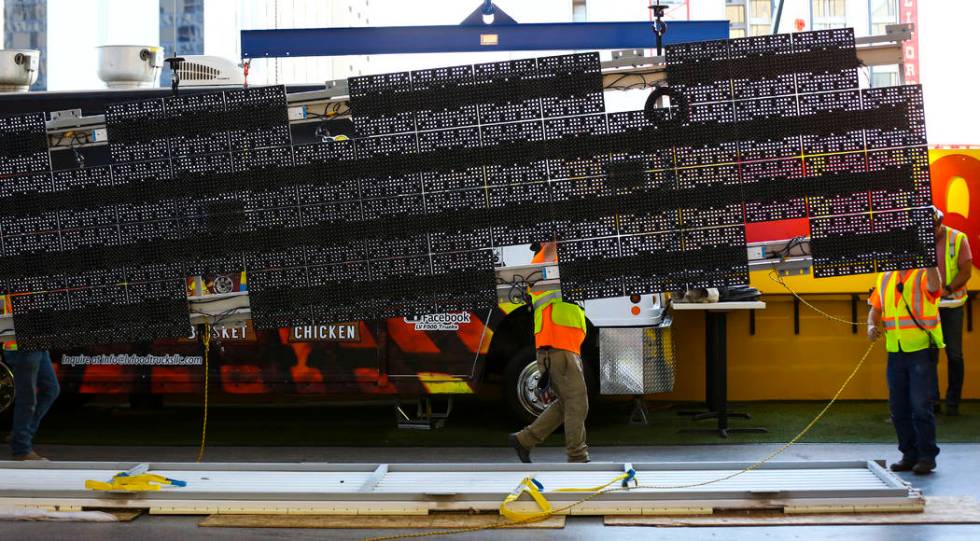 Construction workers prepare to installl a new panel during the second day of renovations of th ...