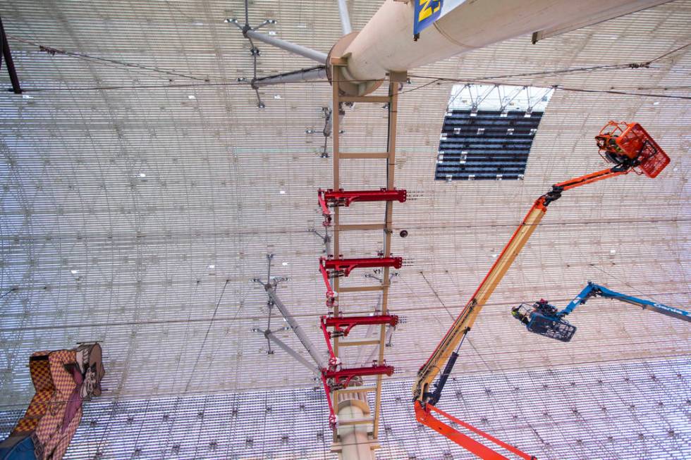 Construction workers install a new panel during the second day of renovations of the Viva Visio ...