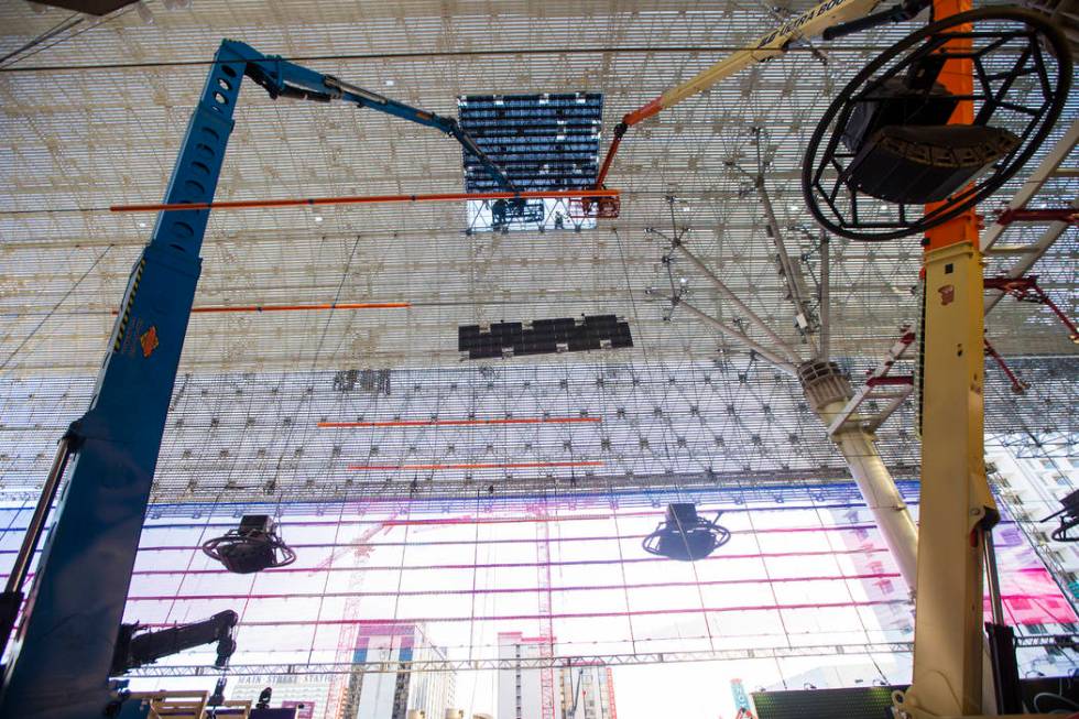 Construction workers install a new panel during the second day of renovations of the Viva Visio ...