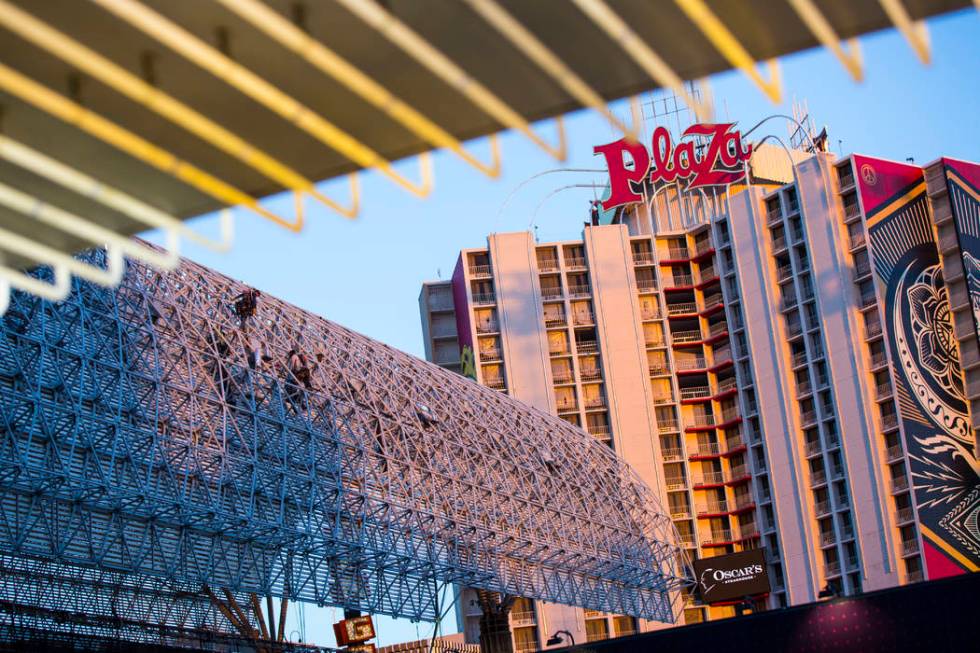 Construction workers work around the exterior of the canopy during the second day of renovation ...