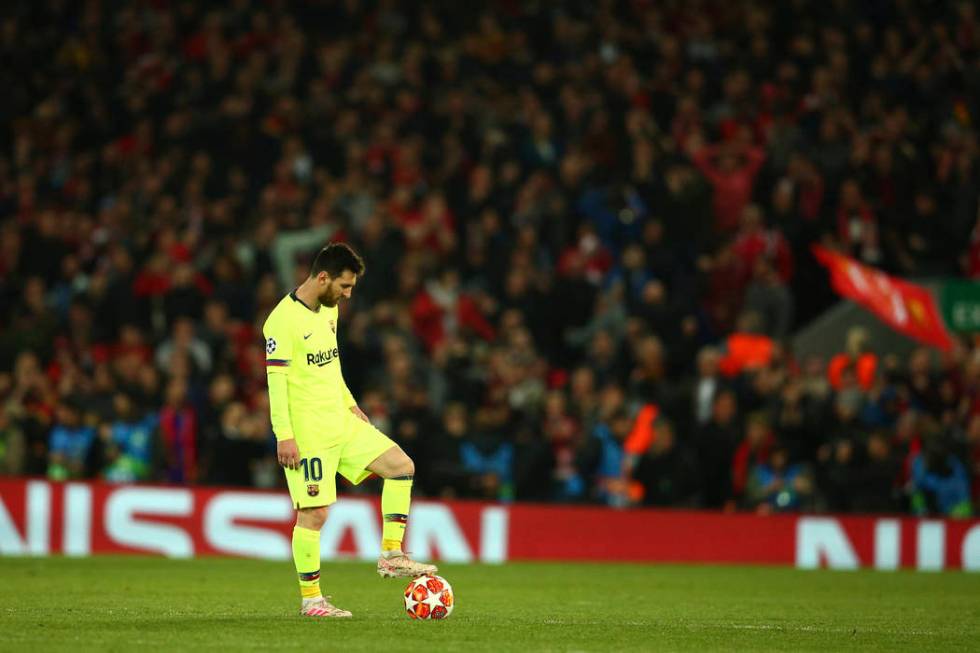 Barcelona's Lionel Messi keeps the ball as Liverpool's Divock Origi celebrates scoring his side ...