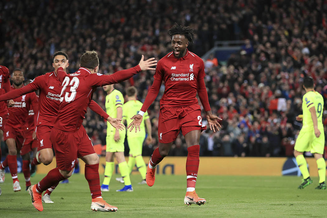 Liverpool's Divock Origi, center, celebrates scoring his side's fourth goal of the game during ...