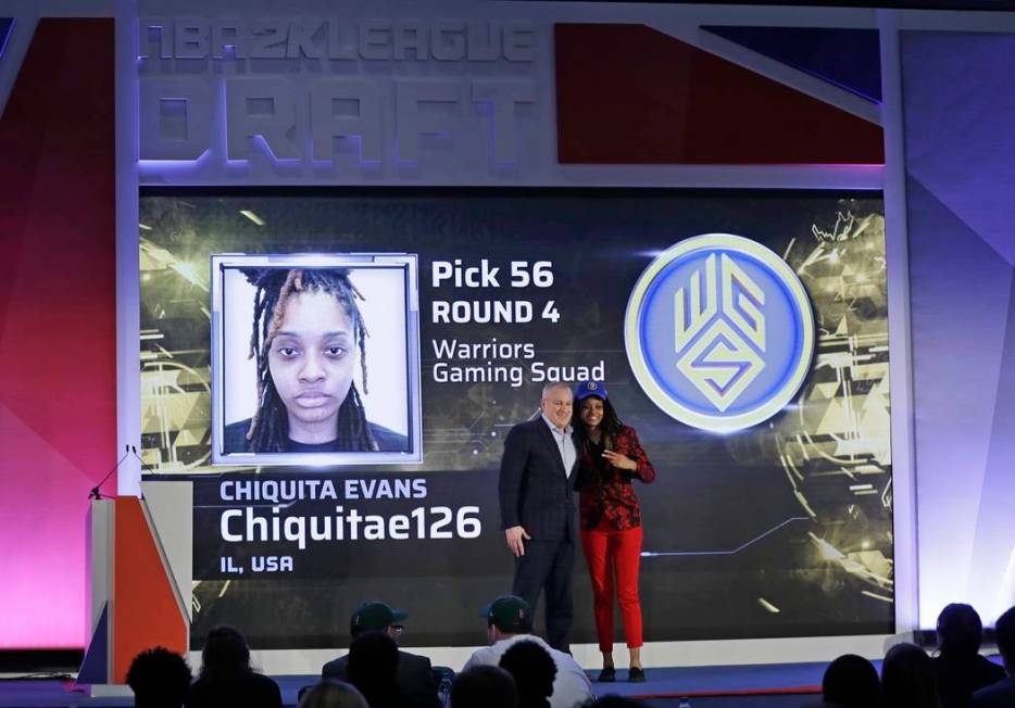 Chiquita Evans poses for photographs with Brendan Donohue after being selected as the 56th pick ...