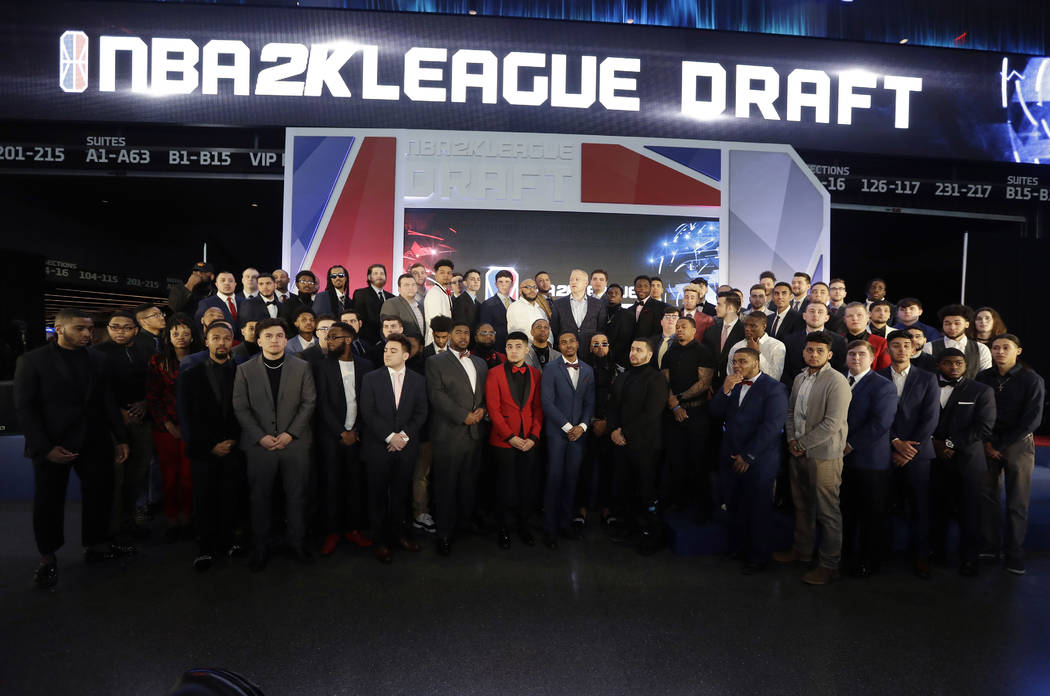 Brendan Donohue, managing director of the new NBA 2K esports league, center, poses for photogra ...