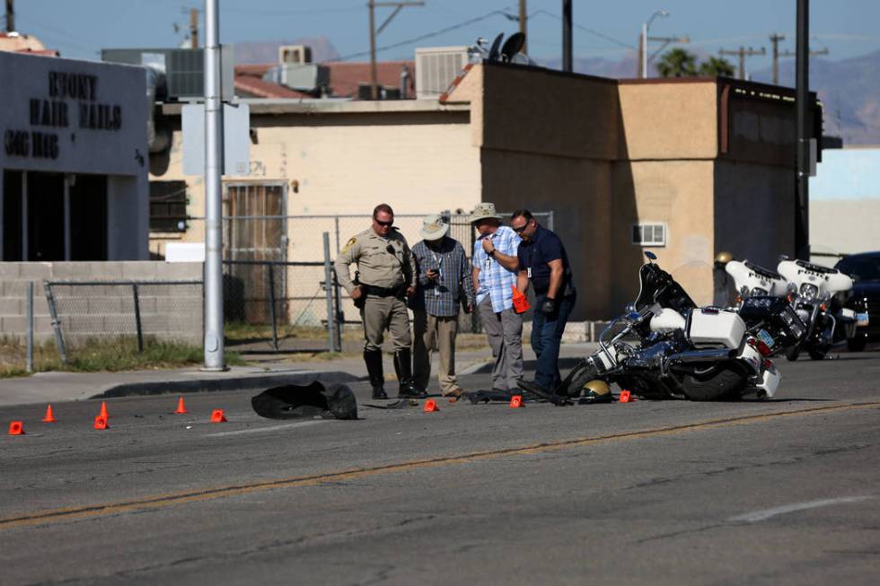 A Las Vegas motorcycle officer suffered minor injuries when a driver he had stopped for a traff ...