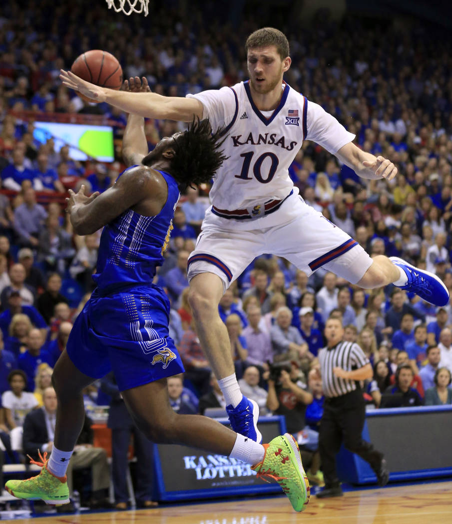 South Dakota State guard David Jenkins Jr. (5) is fouled by Kansas guard Sviatoslav Mykhailiuk ...