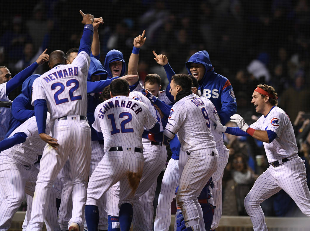 Chicago Cubs players celebrate after Kris Bryant hit a walk-off three-run home run during the n ...