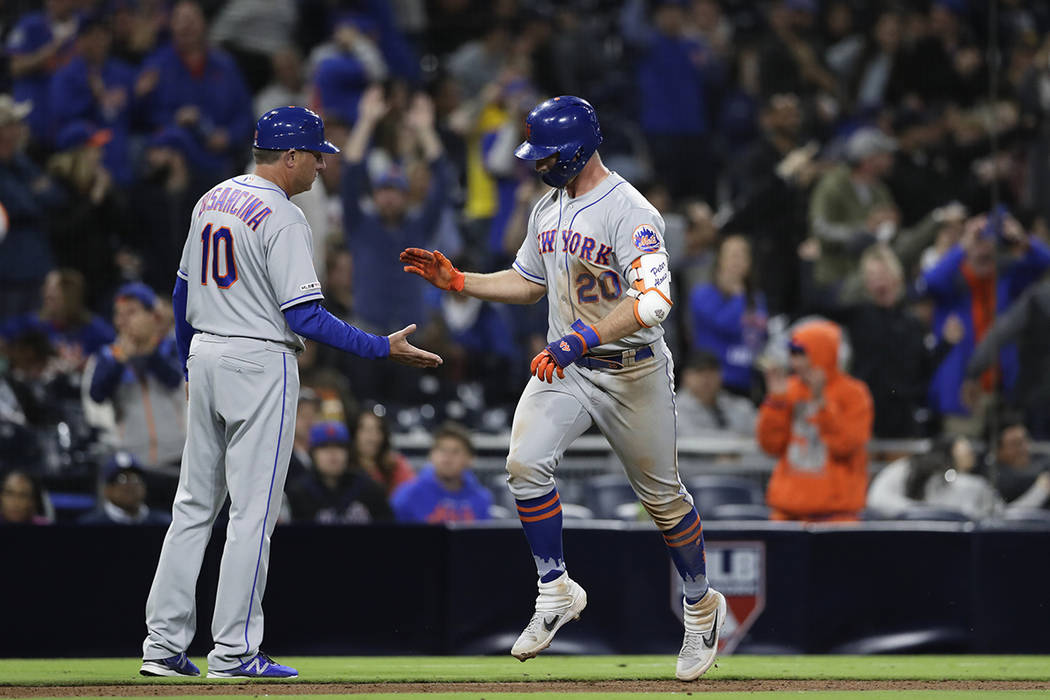 The New York Mets' Pete Alonso, right, is greeted by third base coach Gary Disarcina after hitt ...