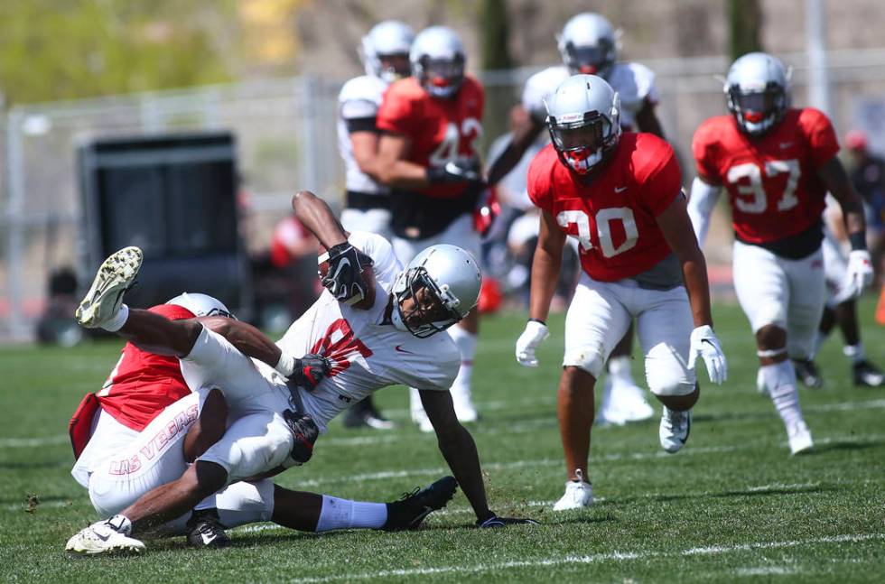 UNLV Rebels wide receiver Patrick Ballard (85) is taken down by running back Tyree Jackson duri ...