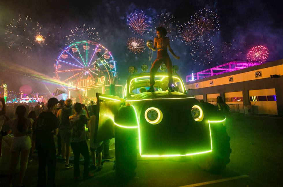 Deven Williams of the Kalliope dances on an art car as fireworks go off during the third day of ...