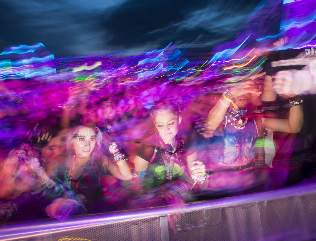 Attendees dance as Dateless performs at the Stereobloom stage during the third day of the Elect ...