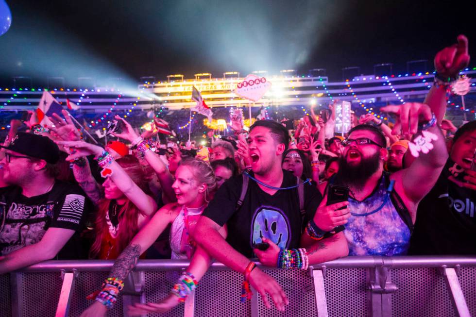 Attendees sing along as Post Malone performs at the Cosmic Meaddow stage during the third day o ...