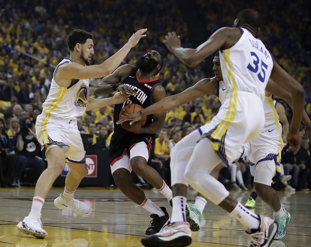 Houston Rockets' James Harden, second from left, drives the ball against Golden State Warriors' ...