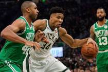 Milwaukee Bucks' Giannis Antetokounmpo tries to drive past Boston Celtics' Al Horford during th ...