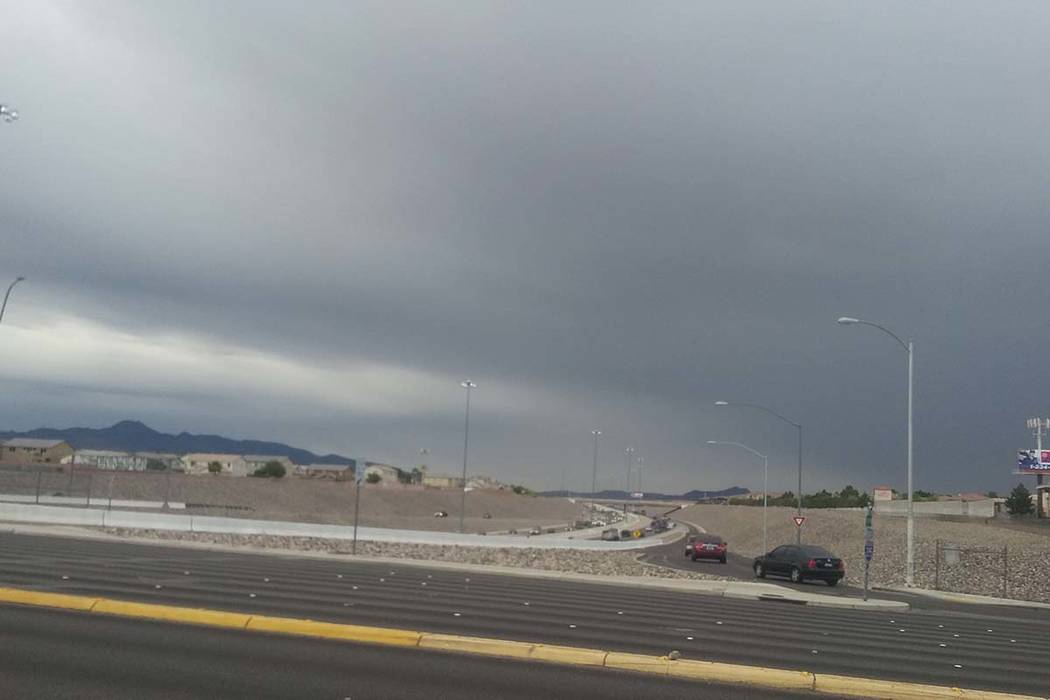 Dark clouds are seen from the 215 Beltway and Windmill Lane in the south part of the Las Vegas ...