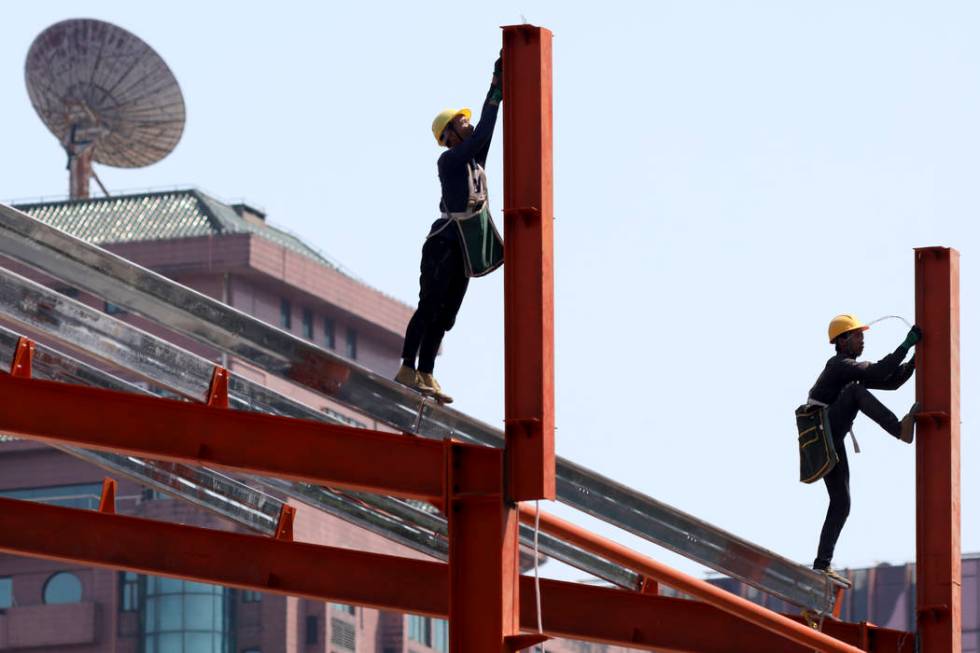 Workers labor in downtown Beijing on Thursday, May 9, 2019. The U.S. effort to win concessions ...