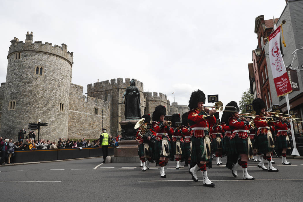 The Royal Regiment of Scotland band march by Windsor Castle, in Windsor, south England, Tuesday ...
