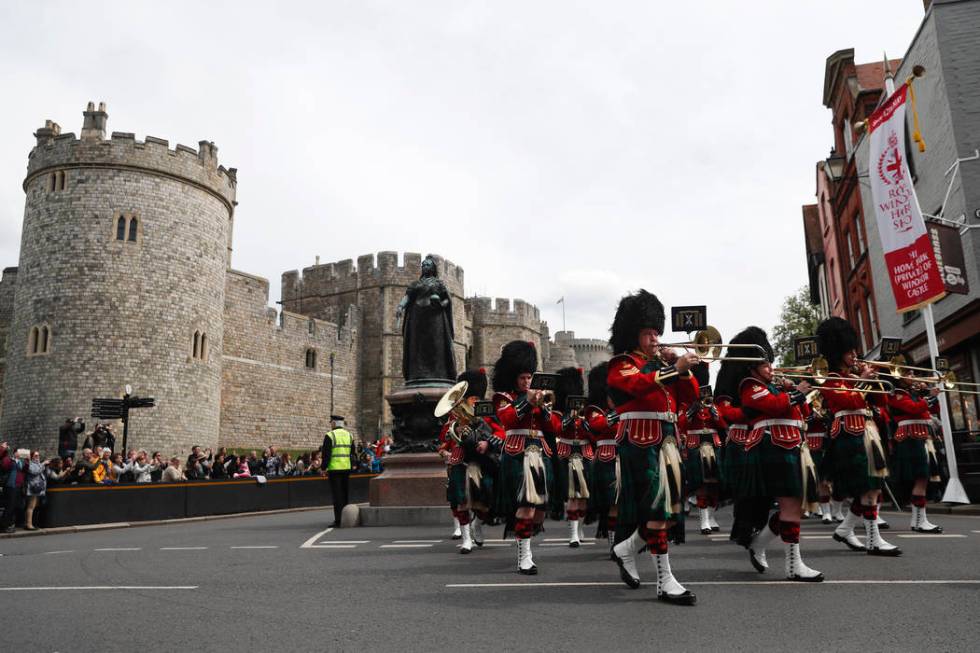 The Royal Regiment of Scotland band march by Windsor Castle, in Windsor, south England, Tuesday ...