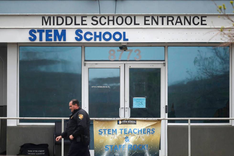 A Douglas County, Colo., Sheriffs Department deputy walks past the doors to the STEM Highlands ...