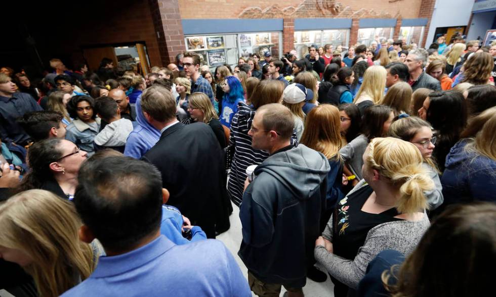 Students and other attendees walk out of a community vigil to honor the victims and survivors o ...