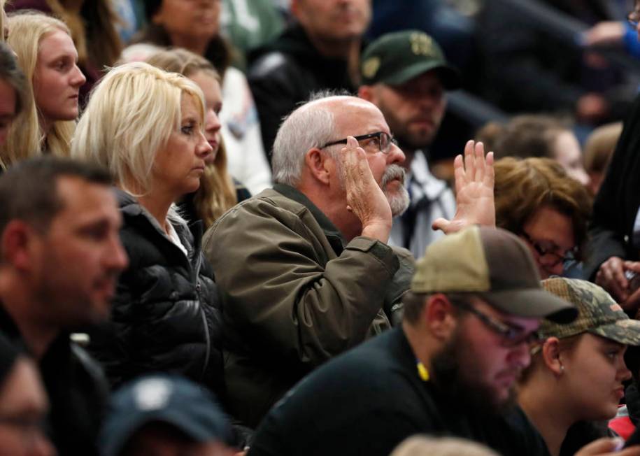 Colorado State Rep. Tom Sullivan, D-Aurora, center, applauds for speakers during a community vi ...